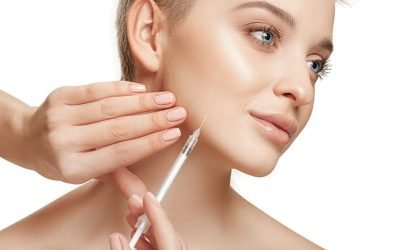 People, Lips, cosmetology, plastic surgery and beauty concept – beautiful young woman face People, Lips, cosmetology, plastic surgery and beauty concept - beautiful young woman face and hand with syringe making injection